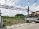 View of a residential area showing external environment with power lines and fencing