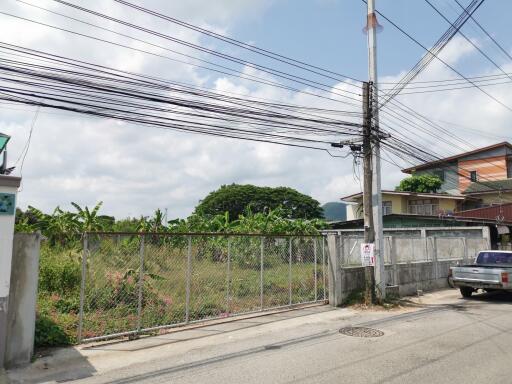 View of a residential area showing external environment with power lines and fencing