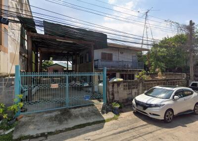 Exterior view of a residential building with gated entrance