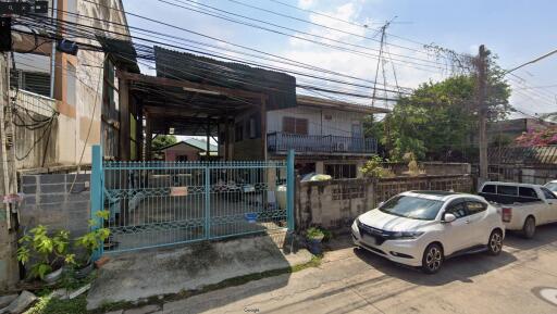 Exterior view of a residential building with gated entrance