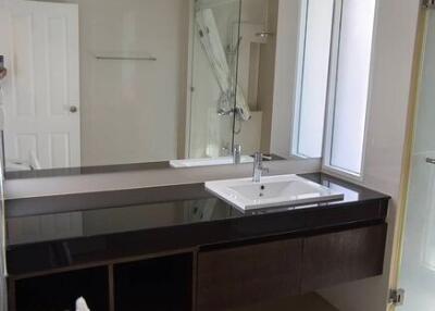 Spacious modern bathroom with dual sinks and glass shower
