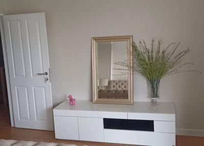 Elegant bedroom entrance with white modern console table and decorative mirror