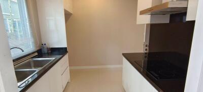 Modern kitchen with stainless steel sink and electric stovetop