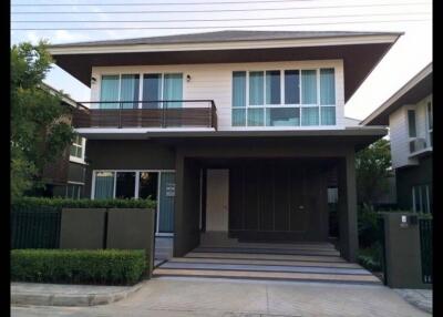 Modern two-story house with balcony and driveway