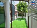 Lush Green Outdoor Space with Artificial Grass and Privacy Fencing