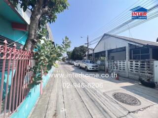 Street view of residential area with visible properties and parked cars