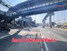 Urban street scene with overpass and commercial signage