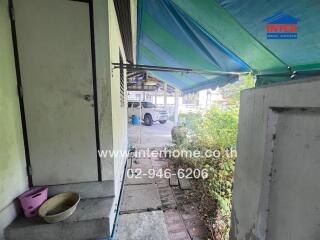 View of the covered entryway leading to a parking area