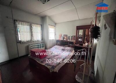 Spacious bedroom with natural light and traditional furnishings