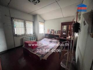 Spacious bedroom with natural light and traditional furnishings