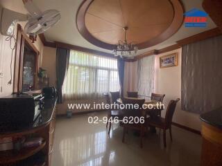 Elegant dining room with large circular ceiling feature and ample natural light