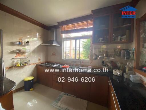 Spacious kitchen with natural lighting and modern appliances