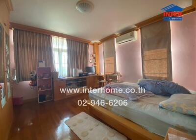 Spacious bedroom with natural lighting and modern amenities