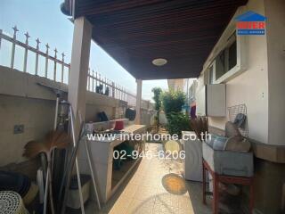 Spacious covered patio area with utility zone in a residential house