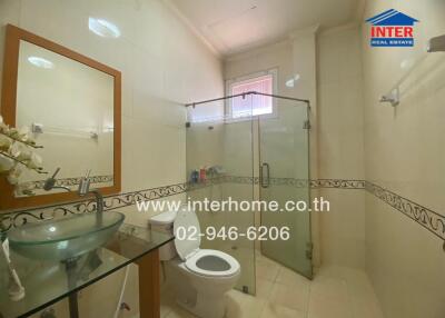 Modern bathroom with transparent shower area and elegant sink