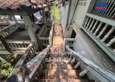 Old weathered staircase between residential buildings