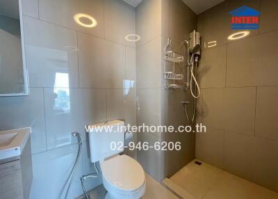 Modern bathroom interior with well-lit vanity area and glass shower