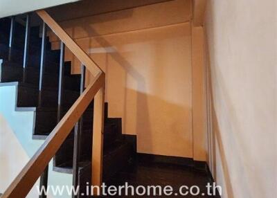 Interior staircase in a home showing steps and handrail
