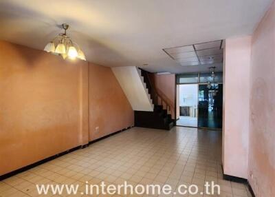 Spacious living room with staircase and tiled flooring