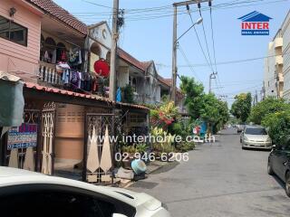 Street view of a residential neighborhood showing a row of townhouses