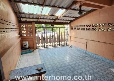 Spacious covered patio with decorative floor tiles and natural lighting