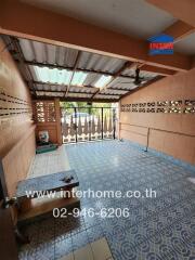 Spacious covered patio with decorative floor tiles and natural lighting