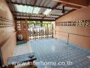 Spacious covered patio with decorative floor tiles and natural lighting