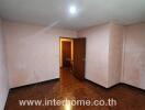 Empty bedroom with parquet flooring and light pink walls