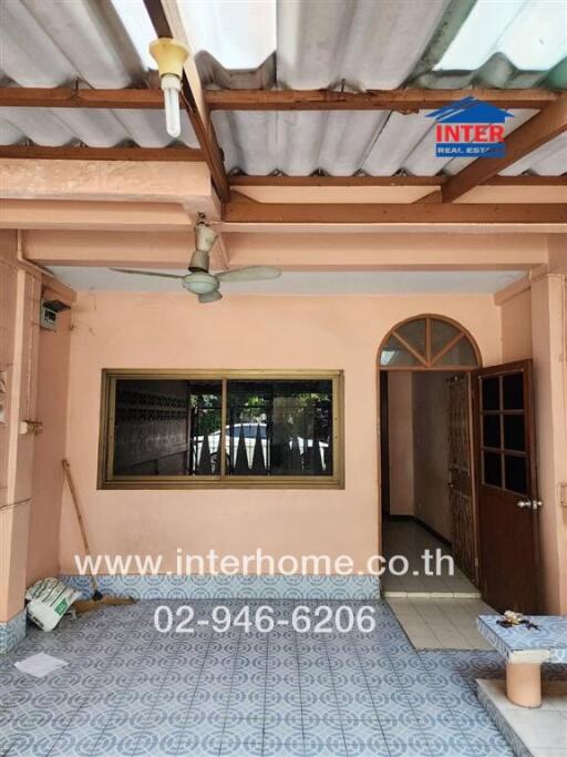 Spacious covered patio with multiple doors and large window