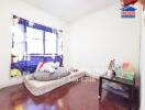 Bright and cozy bedroom with large window and decorative curtain