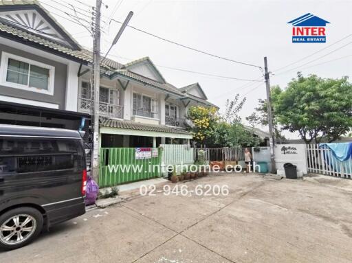 Exterior view of a residential townhouse with gated entrances