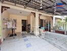 Spacious covered outdoor area with tiled flooring and storage shelves