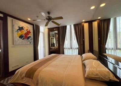 Elegant bedroom with modern decor and large windows