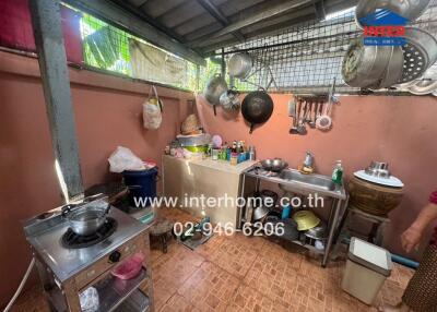 Messy and cluttered home kitchen with visible utensils and cookware