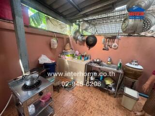 Messy and cluttered home kitchen with visible utensils and cookware