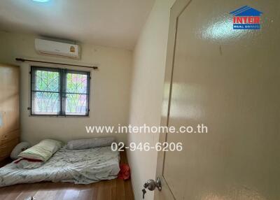 Small bedroom with natural light and air conditioning