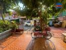 Spacious and welcoming front yard with lush greenery and tiled flooring