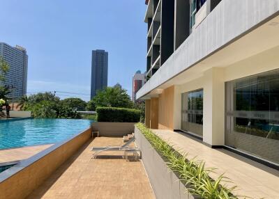 Luxurious poolside with adjacent fitness center and modern building architecture