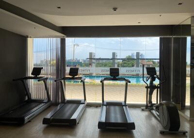 Modern in-house gym with large windows overlooking the city