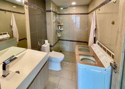 Spacious modern bathroom with integrated laundry facilities