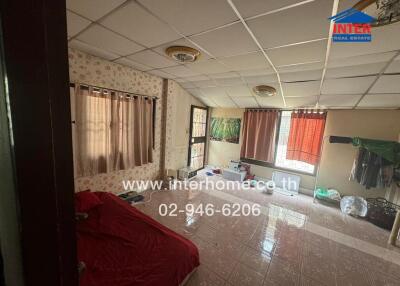 Spacious bedroom with natural lighting and tile flooring