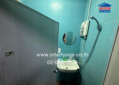 Compact bathroom with blue tiles and modern fixtures