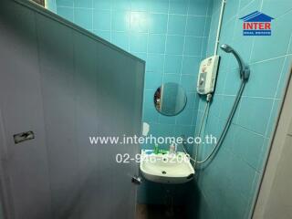 Compact bathroom with blue tiles and modern fixtures