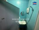 Compact bathroom with blue tiles and modern fixtures