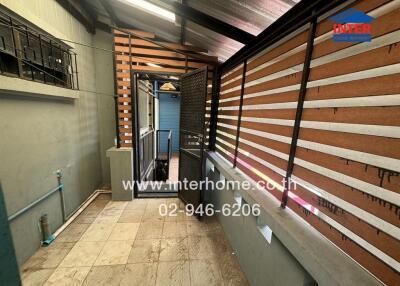 Modern residential entryway with wooden slat design and tiled flooring