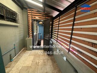 Modern residential entryway with wooden slat design and tiled flooring