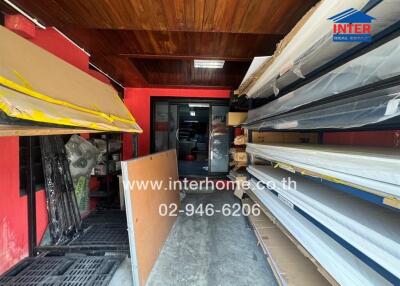 Spacious storage room with wooden ceiling and organized shelving