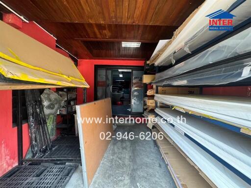 Spacious storage room with wooden ceiling and organized shelving