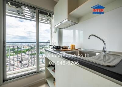 Modern kitchen with city view and stainless steel appliances