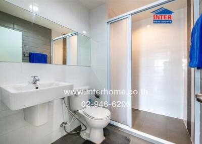 Modern bathroom with glass shower enclosure and white fixtures